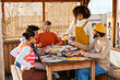 © BONNINSTUDIO/Stocksy - Group of diverse friends having dinner in a rooftop