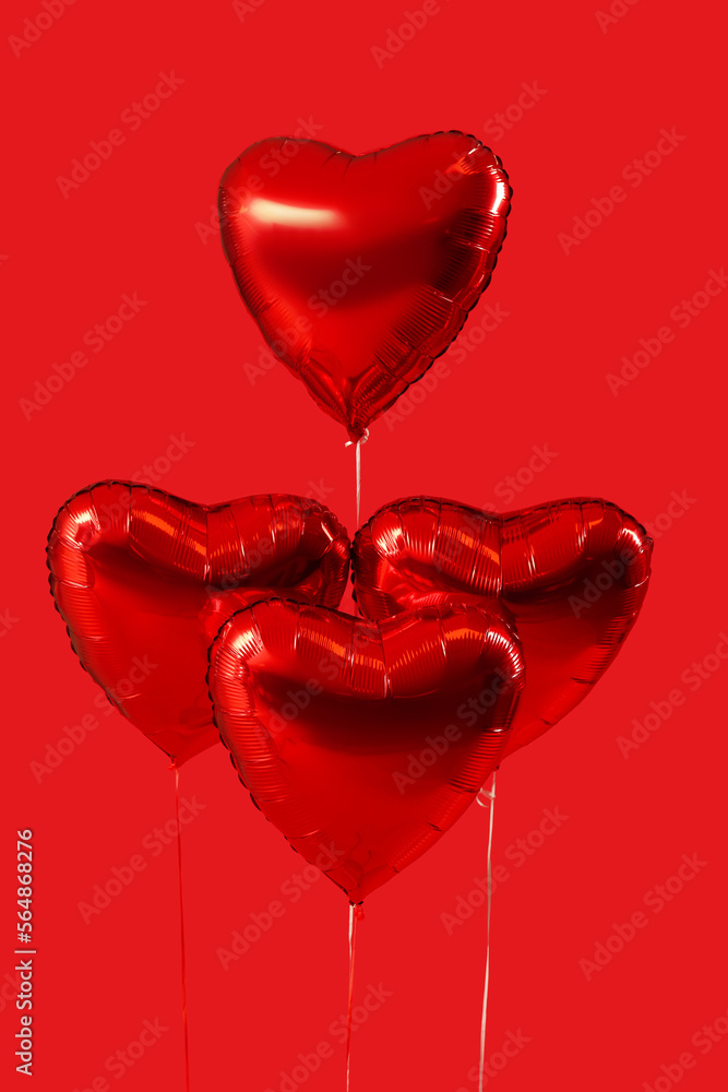 Heart shaped balloons for Valentine's Day on red background