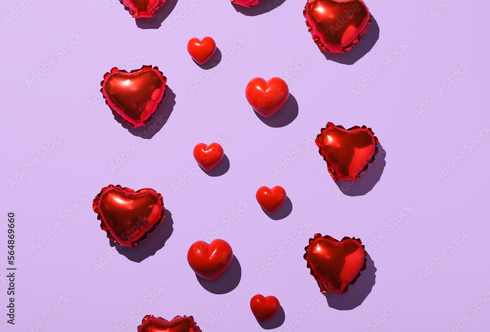 Composition with heart shaped balloons and decor on lilac background. Valentine's Day celebration