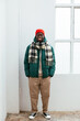 © BONNINSTUDIO/Stocksy - Man in warm clothes standing near window