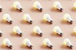 © Davide Illini/Stocksy - Many light bulbs on a pastel background. Concept 3d illustration.