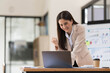 © wichayada - Pretty Asian businesswoman sitting on a laptop And the work came out successfully and the goal was achieved, happy and satisfied with her.