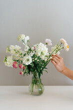 Person Collecting Bouquet Of Flowers In Vase