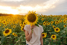 Person Covering Face With Sunflower