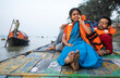 © Dream Lover/Stocksy - Young Couple Enjoying Travel Sitting On A Boat Over River Ganga,India