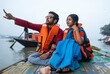 © Dream Lover/Stocksy - Young Couple Enjoying Travel Sitting On A Boat Over River Ganga,India