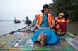 © Dream Lover/Stocksy - Young Couple Enjoying Travel Sitting On A Boat Over River Ganga,India
