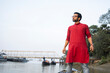 © Dream Lover/Stocksy - Indian young man standing by the side of a river at outdoors