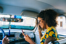 A Girl Uses The Phone Inside A Taxi