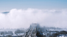 Modern Bridges Covered With Fog, Vehicles Moving On Bridges. Winter Frosts.
