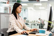 © Santi Nuñez/Stocksy - Asian Businesswoman Using Computer