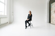 © Hernandez & Sorokina/Stocksy - Woman Sitting On The Chair In Studio