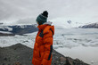 © Anastasia Mihaylova (Shpara)/Stocksy - Female Explorer in red jacket Hiking Around Glacier Lagoon In Iceland