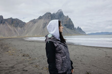Portrait Of Woman In Iceland On Black Sand Beach
