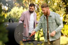 Male Friends Grilling Food Outdoors 