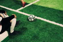 Close Up Of Soccer Ball With People Sitting Besides