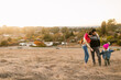 © ByLorena/Stocksy - Family enjoy together by the field in autumn