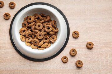 Wall Mural - A bowl of dog food on a wooden floor.