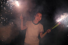 Asian Woman, Playing Fireworks Outdoors At Night In Nature