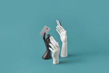 Black And White Hands Holding Credit Cards.