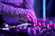 © Ivan Ozerov/Stocksy - Female DJ turning switches on console