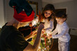 © Vradiy Art/Stocksy - Family decorates the Christmas tree