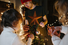 Family Decorates The Christmas Tree