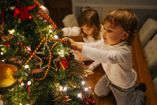 Children Decorate Little Christmas Tree