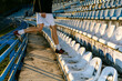 © Artem Podrez/Stocksy - The guy walks on the seats at the stadium