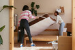 © BONNINSTUDIO/Stocksy - Young woman unpacking boxes in new apartment in new apartment