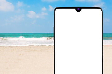 Aufkleber - Modern Mobile Phone with Blank Screen in front of Ocean or Sea Sand Beach. 3d Rendering
