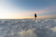 © Kike Arnaiz/Stocksy - Woman walking alone in the world's largest salt flat