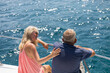 © Marko/Stocksy - Couple conversation on boat at vacation ocean