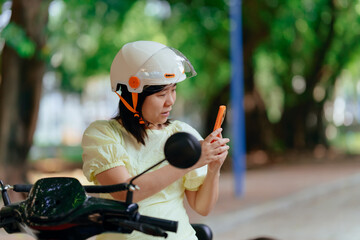 woman using mobile phone on a stopped electric bicycle