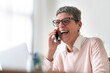 © Studio Marmellata/Stocksy - Happy woman talking on smartphone