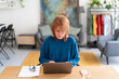 © Studio Marmellata/Stocksy - Senior woman using laptop in office