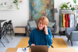 © Studio Marmellata/Stocksy - Woman working on laptop and answering a call
