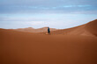 © Mauro Grigollo/Stocksy - Man walking alone in the Desert
