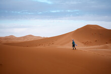 Man Walking Alone In The Desert