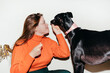 © Lucas Ottone/Stocksy - Woman and black greyhound dog