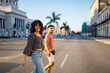 © Daniel Gonzalez/Stocksy - Happy Cuban couple crossing street