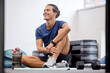 © Joshua A/peopleimages.com - Fitness, relax or happy sports man at gym after training, workout or exercise resting on a break. Tired, smile or healthy athlete with fatigue relaxing on a mat alone after exercising for body goals