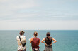 © Luis Herrera/Stocksy - group of travel friends at the beach