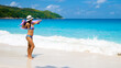 Young Asian woman at a white tropical beach Anse Lazio beach Praslin Tropical Seychelles Islands. 