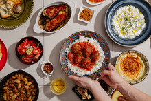 Serving Meatballs On The Table Full Of Traditional Greek Food