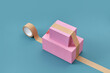 © Yaroslav Danylchenko/Stocksy - Two pink parcels stuck with packing tape.
