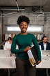 © Aleksandra Jankovic/Stocksy - Portrait Of Smiling Black Woman In The Office