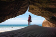 © Luis Herrera/Stocksy - travel woman exploring nature at the beach