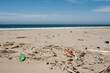 © Luis Herrera/Stocksy - sand beach full of trash