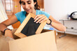 © Luis Herrera/Stocksy - woman home moving